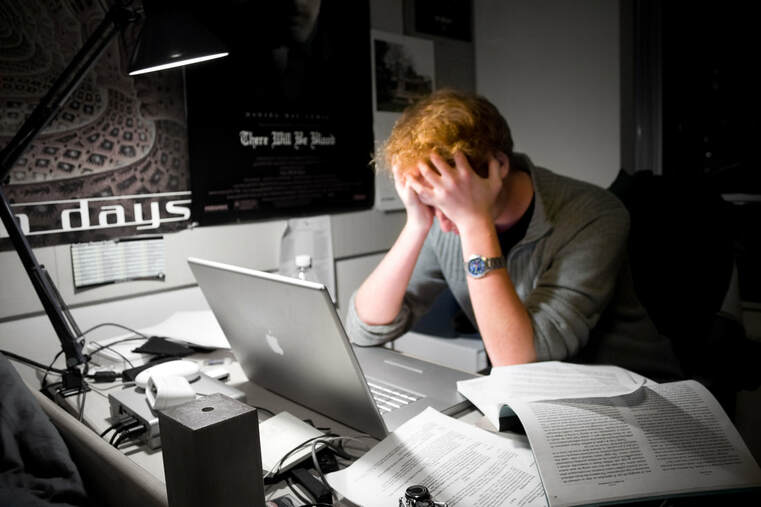 Picture of man frustrated at computer doing work
