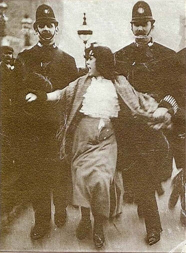 The arrest of teenage suffragette by policemen in 1907.